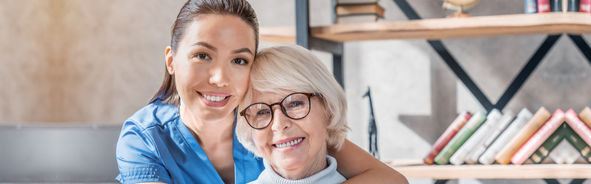 caregiver hugging senior